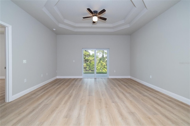 47 Providence Ln, Palm Coast, FL 32164 - unfurnished room with a raised ceiling, ceiling fan, light wood-style flooring, and baseboards