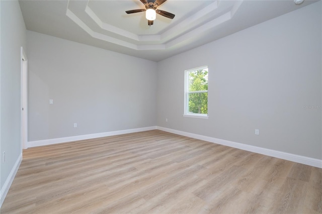 47 Providence Ln, Palm Coast, FL 32164 - empty room featuring a tray ceiling, a ceiling fan, light wood finished floors, baseboards, and a smoke detector