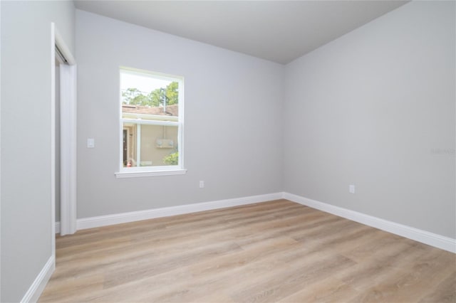 47 Providence Ln, Palm Coast, FL 32164 - spare room featuring light wood-style floors and baseboards