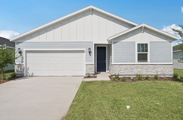 9 Wandering Crk, Way, Palm Coast, FL 32164 - view of front facade featuring stone siding, driveway, board and batten siding, an attached garage, and a front yard