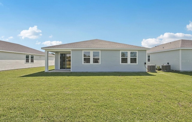 9 Wandering Crk, Way, Palm Coast, FL 32164 - back of property featuring a lawn, central air condition unit, and a shingled roof