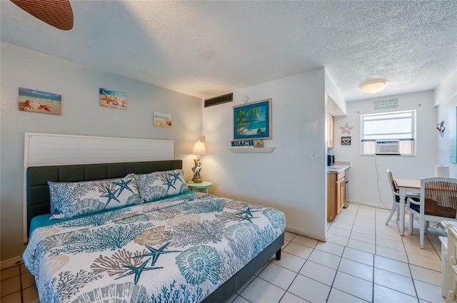 219 S Atlantic Ave Unit 204, Daytona Beach, FL 32118 - bedroom with a textured ceiling, light tile patterned floors, and cooling unit