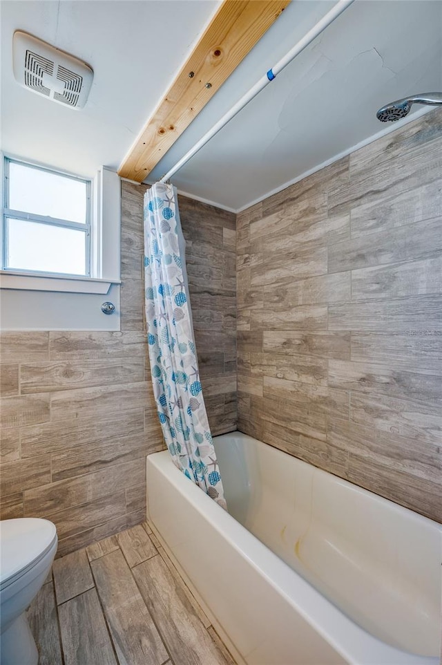 219 S Atlantic Ave Unit 204, Daytona Beach, FL 32118 - full bathroom with tile walls, toilet, and shower / bath combination with curtain