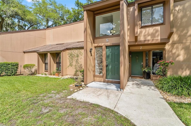 8 Oakmont Ct Unit 0, Palm Coast, FL 32137 - doorway to property with a yard