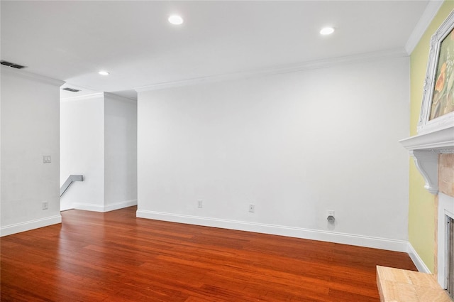 8 Oakmont Ct Unit 0, Palm Coast, FL 32137 - empty room with a tile fireplace, ornamental molding, wood finished floors, baseboards, and recessed lighting