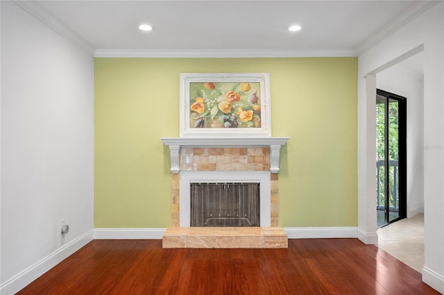 8 Oakmont Ct Unit 0, Palm Coast, FL 32137 - unfurnished living room featuring wood finished floors, crown molding, baseboards, a tiled fireplace, and recessed lighting