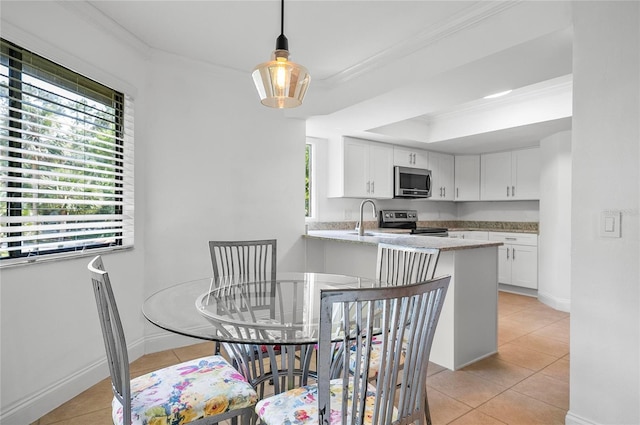 8 Oakmont Ct Unit 0, Palm Coast, FL 32137 - dining room featuring light tile patterned flooring, ornamental molding, and baseboards