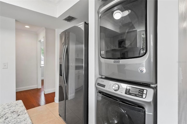 8 Oakmont Ct Unit 0, Palm Coast, FL 32137 - laundry room featuring stacked washer / dryer, baseboards, light wood finished floors, ornamental molding, and recessed lighting