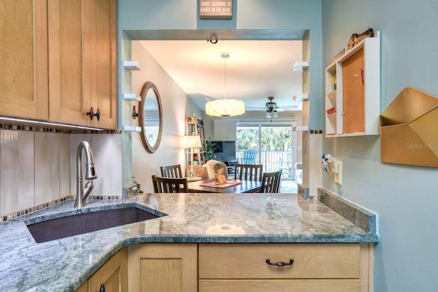 8550 A1A S Unit 323, Saint Augustine, FL 32080 - kitchen with a sink, ceiling fan, hanging light fixtures, and stone countertops