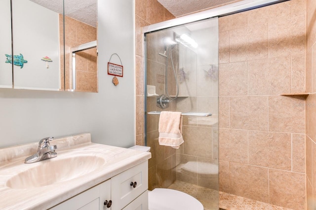 8550 A1A S Unit 323, Saint Augustine, FL 32080 - full bathroom featuring a shower stall, a textured ceiling, vanity, and toilet