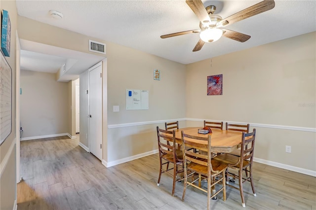 503 Kettering Way, Orange Park, FL 32073 - dining space with light wood-type flooring, ceiling fan, a textured ceiling, and baseboards