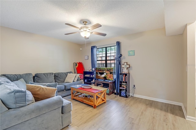 503 Kettering Way, Orange Park, FL 32073 - living area with light wood finished floors, a ceiling fan, baseboards, and a textured ceiling