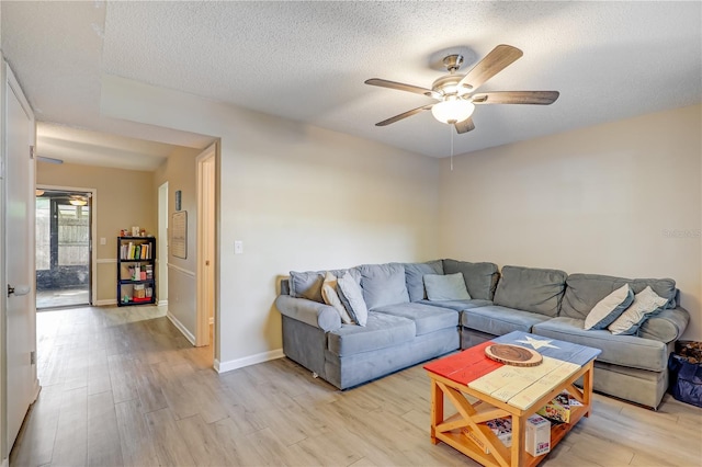 503 Kettering Way, Orange Park, FL 32073 - living room featuring ceiling fan, light wood finished floors, a textured ceiling, and baseboards