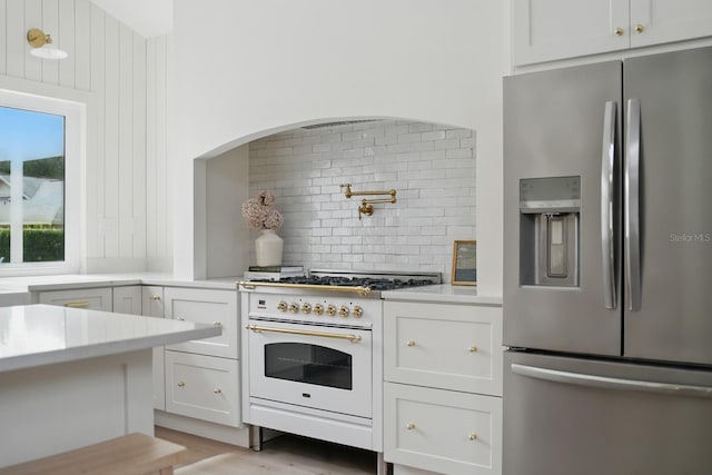3 Cole Pl, Palm Coast, FL 32137 - kitchen featuring stainless steel refrigerator with ice dispenser, high end white range oven, decorative backsplash, light countertops, and white cabinetry