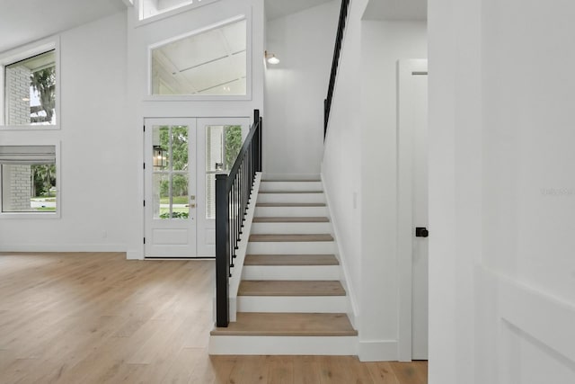 3 Cole Pl, Palm Coast, FL 32137 - staircase featuring wood finished floors, a high ceiling, and baseboards
