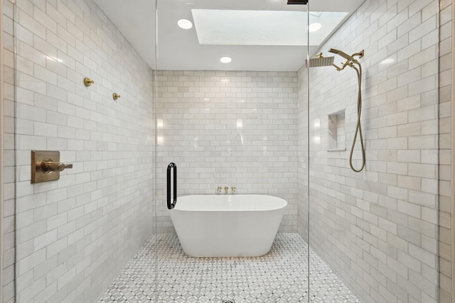 3 Cole Pl, Palm Coast, FL 32137 - bathroom with tile walls, tiled shower, a skylight, and recessed lighting