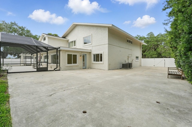 3 Cole Pl, Palm Coast, FL 32137 - rear view of property featuring a gate, a patio, stucco siding, a lanai, and central AC unit