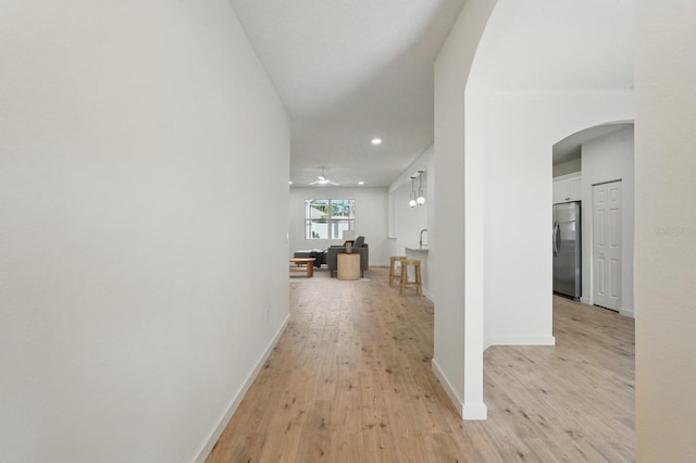40 Pinetree Dr, Palm Coast, FL 32164 - hallway with arched walkways, light wood finished floors, recessed lighting, and baseboards