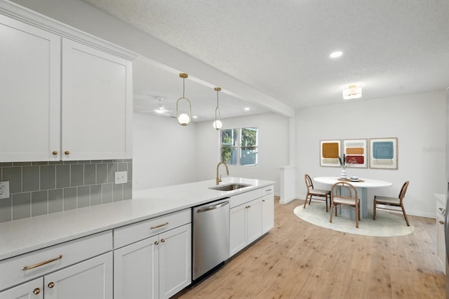 40 Pinetree Dr, Palm Coast, FL 32164 - kitchen featuring dishwasher, a sink, recessed lighting, light wood-style flooring, and tasteful backsplash