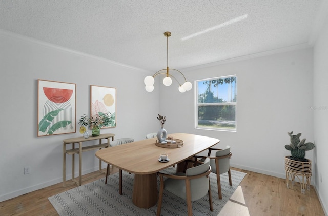40 Pinetree Dr, Palm Coast, FL 32164 - dining area with a textured ceiling, ornamental molding, wood finished floors, a chandelier, and baseboards