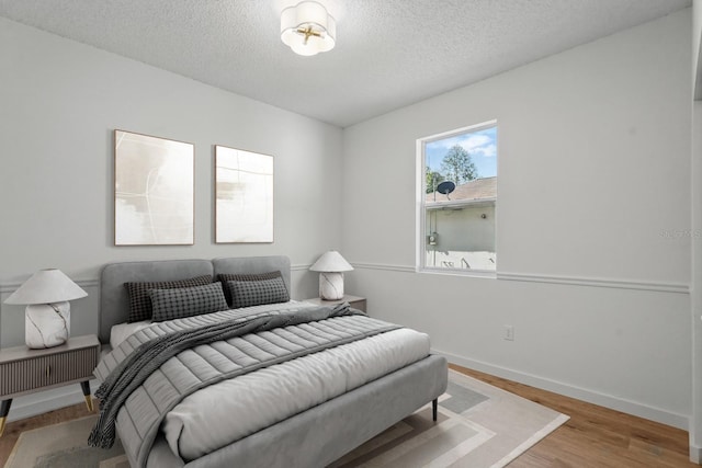 40 Pinetree Dr, Palm Coast, FL 32164 - bedroom featuring wood finished floors, a textured ceiling, and baseboards