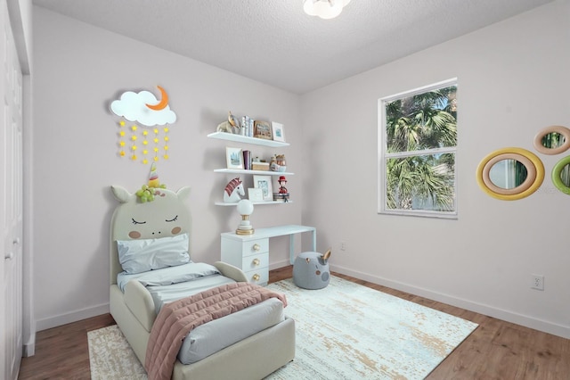 40 Pinetree Dr, Palm Coast, FL 32164 - sitting room featuring wood finished floors, baseboards, and a textured ceiling