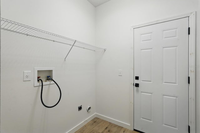40 Pinetree Dr, Palm Coast, FL 32164 - washroom with electric dryer hookup, hookup for a washing machine, light wood-style floors, and baseboards