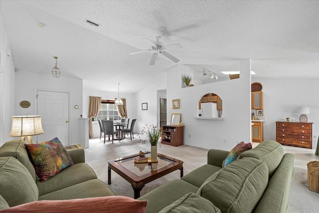 19 Utica Path, Palm Coast, FL 32164 - living room with light colored carpet, vaulted ceiling, a textured ceiling, and a ceiling fan