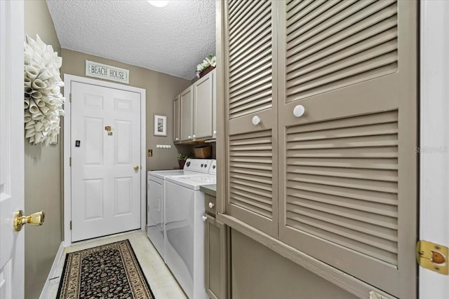 19 Utica Path, Palm Coast, FL 32164 - laundry area featuring cabinet space, washer and dryer, a textured ceiling, and baseboards