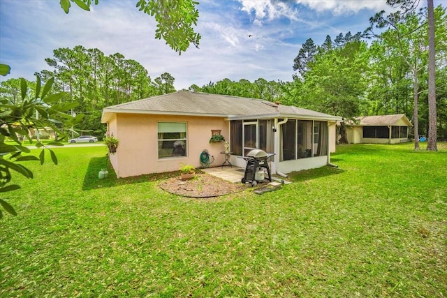 19 Utica Path, Palm Coast, FL 32164 - back of property with a sunroom, stucco siding, and a lawn
