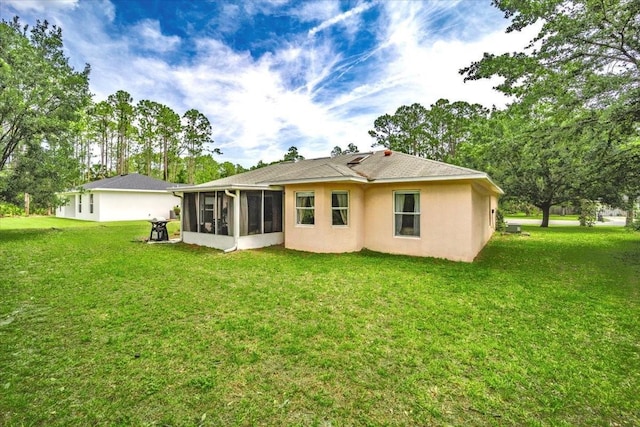 19 Utica Path, Palm Coast, FL 32164 - rear view of house with a sunroom, a yard, and stucco siding