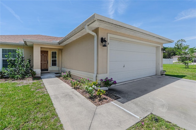 4 Contee Ct, Palm Coast, FL 32137 - view of front of home featuring a garage, concrete driveway, a front lawn, and stucco siding