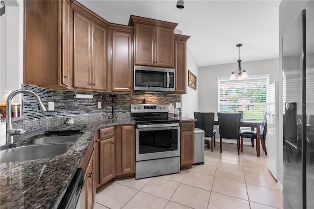 4 Contee Ct, Palm Coast, FL 32137 - kitchen with appliances with stainless steel finishes, a sink, tasteful backsplash, and brown cabinetry