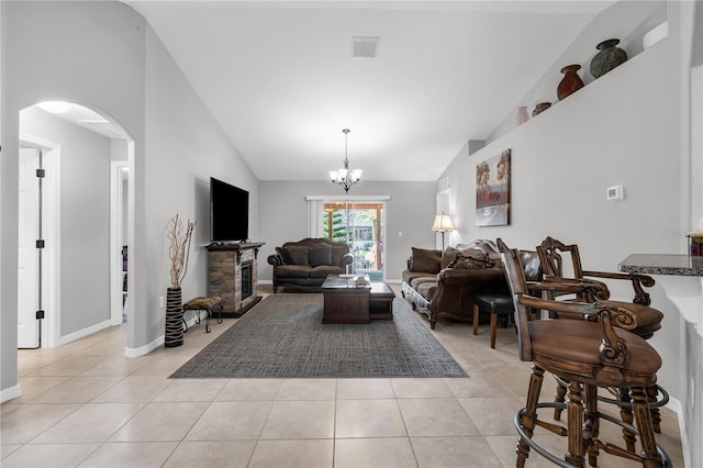 4 Contee Ct, Palm Coast, FL 32137 - living room with arched walkways, light tile patterned floors, a chandelier, baseboards, and high vaulted ceiling