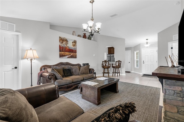 4 Contee Ct, Palm Coast, FL 32137 - living room with a chandelier, light tile patterned floors, baseboards, and arched walkways