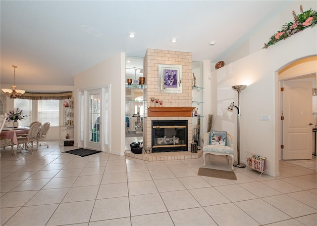 1 Butternut Dr, Palm Coast, FL 32137 - living area featuring light tile patterned flooring, a brick fireplace, a chandelier, baseboards, and lofted ceiling