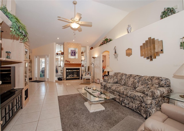 1 Butternut Dr, Palm Coast, FL 32137 - living area with lofted ceiling, light tile patterned flooring, ceiling fan, a brick fireplace, and arched walkways