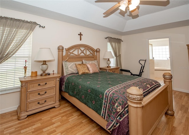 1 Butternut Dr, Palm Coast, FL 32137 - bedroom featuring light wood-type flooring, baseboards, ensuite bathroom, a ceiling fan, and a raised ceiling
