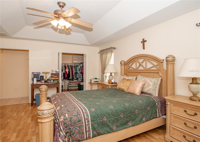 1 Butternut Dr, Palm Coast, FL 32137 - bedroom featuring a raised ceiling, a closet, a walk in closet, and light wood-style flooring