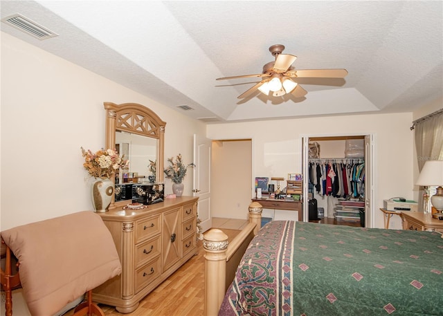 1 Butternut Dr, Palm Coast, FL 32137 - bedroom featuring light wood finished floors, a raised ceiling, a spacious closet, a closet, and a ceiling fan