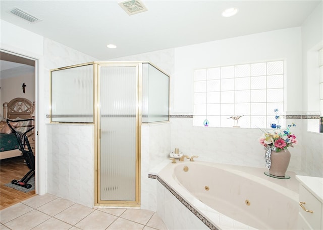 1 Butternut Dr, Palm Coast, FL 32137 - ensuite bathroom featuring a stall shower, a jetted tub, and tile patterned flooring