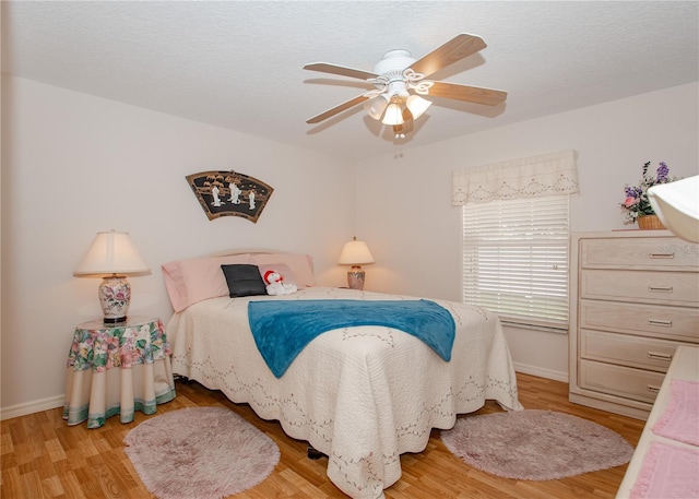 1 Butternut Dr, Palm Coast, FL 32137 - bedroom with wood finished floors, baseboards, and a ceiling fan