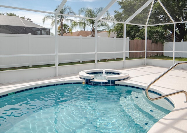1 Butternut Dr, Palm Coast, FL 32137 - view of swimming pool with a patio area, a fenced backyard, glass enclosure, and a pool with connected hot tub