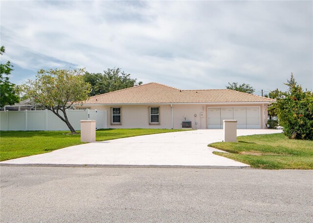 1 Butternut Dr, Palm Coast, FL 32137 - view of front facade with concrete driveway, a garage, a tile roof, stucco siding, and central AC unit