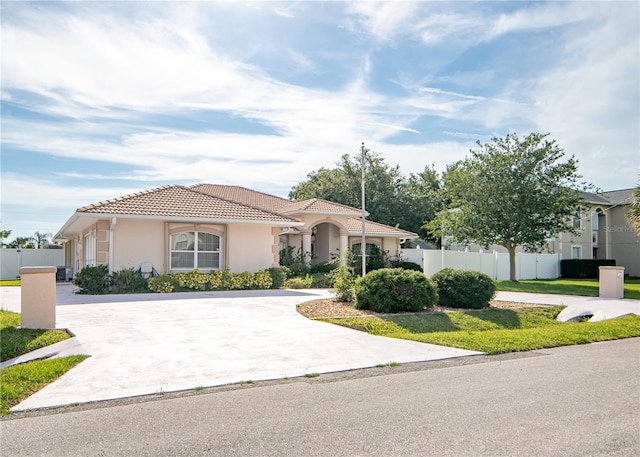 1 Butternut Dr, Palm Coast, FL 32137 - mediterranean / spanish-style home featuring a tiled roof, stucco siding, and concrete driveway