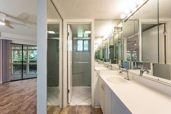9 Masters Ct, Palm Coast, FL 32137 - bathroom with a textured ceiling, vanity, and ceiling fan