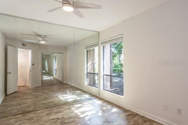 9 Masters Ct, Palm Coast, FL 32137 - unfurnished room with ceiling fan, baseboards, and wood finished floors