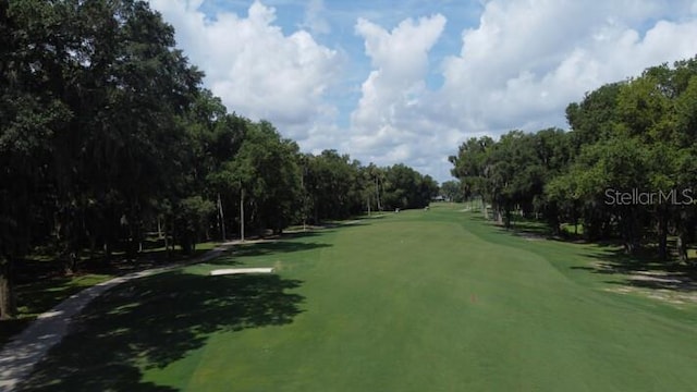 9 Masters Ct, Palm Coast, FL 32137 - view of community with view of golf course, a lawn, and view of scattered trees