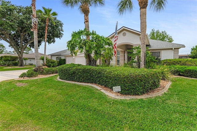 21 Webster Ln, Palm Coast, FL 32164 - view of property hidden behind natural elements with stucco siding, a front yard, and a garage