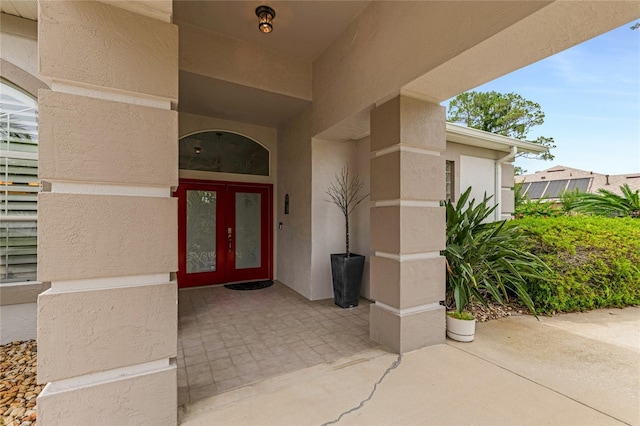 21 Webster Ln, Palm Coast, FL 32164 - view of exterior entry with french doors and stucco siding